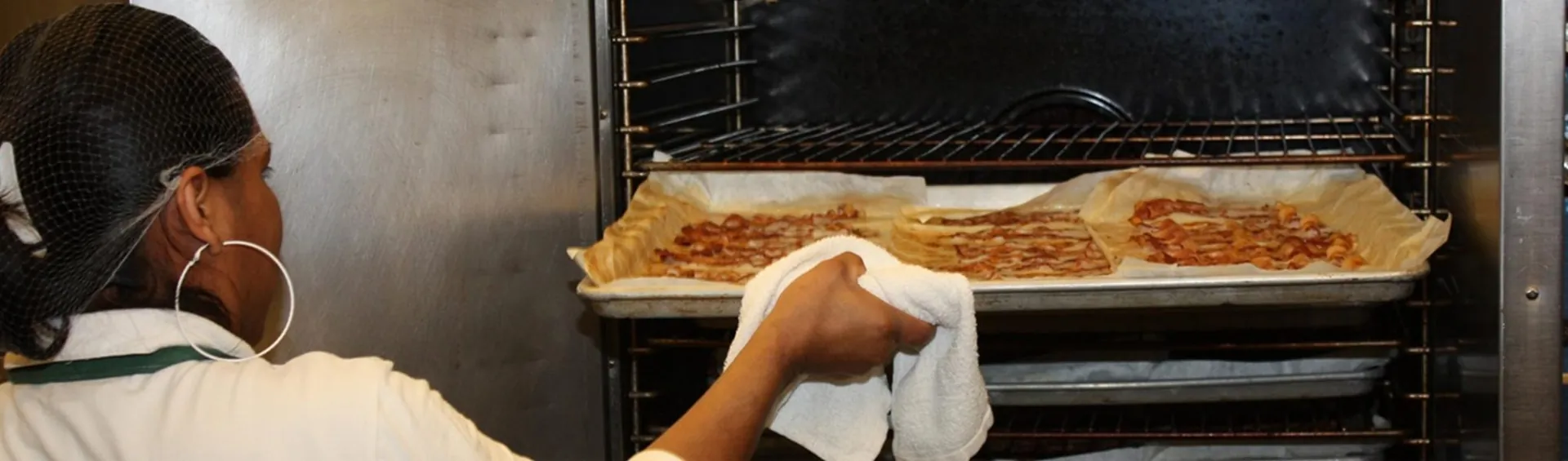 C&H baker pulling homemade pies from the oven