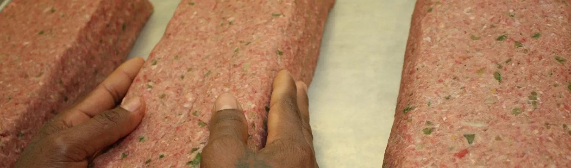 C&H kitchen team shaping meatloaf by hand