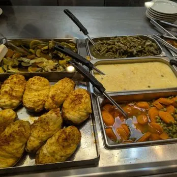 Baked chicken, sautéed squash, green beans, gravy and carrots with peas on the hot line